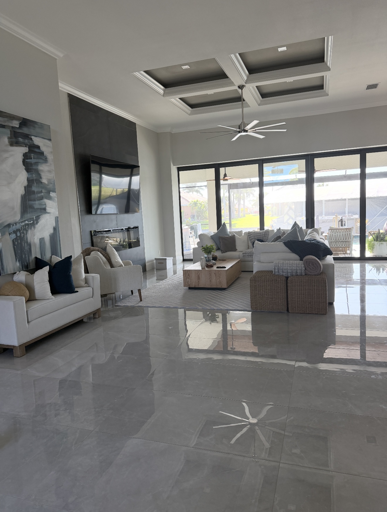 An open living room with neatly arranged seating and a polished tile floor